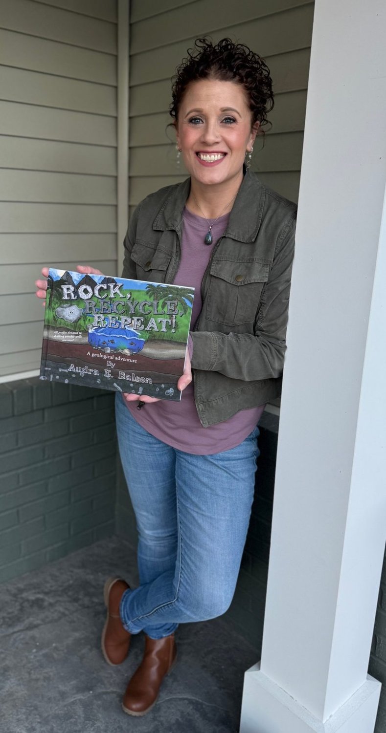 Geologist and author Audra E. Balson holding her book Rock, Recycle, Repeat!